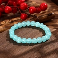 Hellblaues Perlenarmband mit Eisriss-Textur auf dunklem Holzhintergrund präsentiert - Hellblauer Crackle-Stil (GBC025-4)