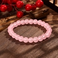 Pink cat eye crystal bead bracelet displayed on a rustic wooden decorative surface - Pink Cat Eye Style (GBC025-21)