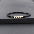 Handmade beaded bracelet featuring glossy black beads and five irregular gold hammered beads - Black (BC493-1)