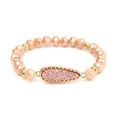 Close-up of beaded stretch bracelet with peach crystals and gold water drop pendant - Peach (BC510-3)