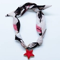 Detail view of a white floral scarf necklace featuring a vibrant red star-shaped pendant - Red Star Floral Print Style (NS02-10)