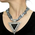 Zebra print scarf necklace with a large black triangular metal pendant on model - Snake Print Triangle Pendant (NS04-1)