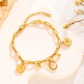 Gold titanium steel link bracelet featuring a letter C charm and vintage coin pendants - Queen Portrait - Letter C (7845)
