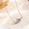 Elegante zilveren ketting met geknoopte hart hanger en verfijnde schakelketting dames - Knoop hanger ketting / Zilver