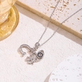Close-up of silver snowflake necklace with horseshoe and evil eye charms on stone - U-Shaped Eye (Evil Eye / Horseshoe / Clover)
