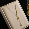 Elegante goldene Titahstah-Halskette mit R-Anhänger und quadratischen Quastendetails - Buchstabe R