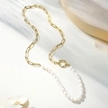 Baroque freshwater pearl and gold paperclip link necklace on a textured stone surface - Gold