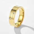 Close-up of golden stainless steel ring with dual grooves and two round diamonds - US 7 / Gold
