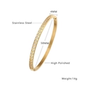 Detail showing 4mm wide gold plated stainless steel bangle with zircon and rhombus pattern - B091-Gold