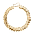 Close-up of golden chunky choker featuring vertical pleated wave texture and metallic finish - Necklace