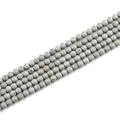 Macro detail of 8mm grey volcanic stone beads with natural porous texture and matte finish - 8mm / Plated White K