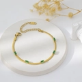 Detailed view of gold plated steel snake chain bracelet with five green zircon stones - Bracelet / Gold + Green Zirconia