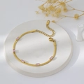 Close-up of gold snake chain bracelet with five pink rectangular zircon gemstones - Bracelet / Gold + Pink Zirconia