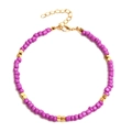 Detail of beaded anklet with purple matte beads and gold square metal accents - Purple Gold