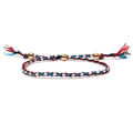 Handmade woven bracelet with red, blue, black, and white cords featuring three gold beads - Red Blue White Black Mix (Style 8)