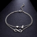 Cavigliera doppia in argento con ciondoli infinito cuore e lettera A da donna - Stile Lettera A