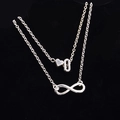 Cavigliera a doppio strato in argento con ciondoli cuore e infinito su velluto nero - Stile Lettera O
