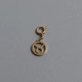 Macro shot of gold-plated Taurus zodiac pendant with spring ring clasp on gray background - Taurus (With Spring Ring Clasp)