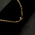 Detailed close-up of a gold rope chain necklace featuring a secure lobster clasp closure - 2.4mm Width * 60CM Length / Gold