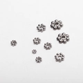 Detailed macro view of various sizes of stainless steel flower spacer beads for DIY jewelry - 3mm / Silver