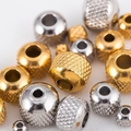 Macro view of gold and silver stainless steel spacer beads with knurled mesh texture - 4*1.5mm / Gold