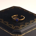 Makroaufnahme eines Vintage-Goldrings mit blauem Tropfenstein auf Schmuckbox - Blau Stil (R00027BL)