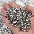 Close-up of polished silver stainless steel spacer beads held in hand for jewelry making - Stainless Steel Color-2x1x1.4mm (Can Be Flattened)