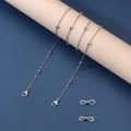 Detail of silver beaded eyewear chain with lobster clasps and white silicone loops - Silver