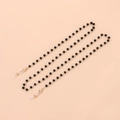 Detail of eyeglass chain with black beads and gold lobster clasps on pink background - Gold Black Beads