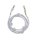 Detail of white beaded eyewear chain with heart accents and golden lobster clasps - Gold