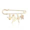 Golden safety pin brooch featuring fairy on moon, palm tree, heart, and crystal butterfly - Gold