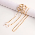 Macro detail of golden eyeglass chain featuring textured hollow rings and silicone loops - Spiral Textured Hollow Ring Decorative Style (6#)