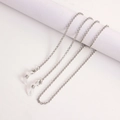 Detailed macro view of silver metal eyeglass chain with lobster clasps and silicone loops - Small Link Chain White K