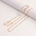 Detail van gouden brillenkoord met blauwe boze oog kralen en siliconen antislip lussen - Boho Blauw Oog Stijl (5#)