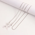 Silver snake chain glasses strap with lobster clasps and clear silicone ends on white stand - 4# White K