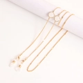 Detail of gold metal eyewear chain featuring white translucent beads and silicone loops - White Stone Style (1#)