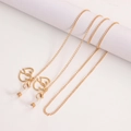 Detailed close-up of golden eyeglasses chain featuring heart pendants and lobster clasps - Gold