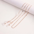 Elegant rose gold metal chain for glasses and masks with lobster clasps on beige background - Rose Gold