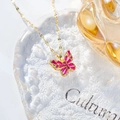 Close-up of butterfly pendant with pink purple baguette zircon in gold setting - Hollow Butterfly Necklace / Rose Red