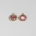 Macro shot of pink gemstone evil eye pendants with gold plated beaded edge for DIY jewelry - Pink