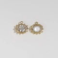 Detail of gold oval Evil Eye charms with faceted clear crystals and beaded metal edges - White