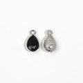 Detailed view of silver teardrop pendants with black faceted stone and floral engraving - Black