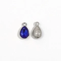 Detail of teardrop silver charm with royal blue crystal and floral engraved back - Blue