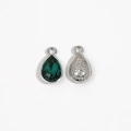 Silver teardrop crystal pendant with dark green gemstone and floral embossed back side - Green