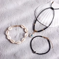 Bohemian 3-piece set with shell and evil eye beads on light sandy beach background - Black