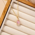 Pink teardrop crystal necklace with gold plated chain on beige velvet jewelry box - Pink