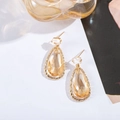 Detail of elegant teardrop champagne crystal earrings with pear-cut stones in gold frames - Champagne
