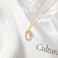 Minimalist gold necklace featuring a zircon-inlaid oval floral pendant on a fine link chain - Letter O
