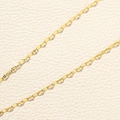 Detailed macro view of golden stainless steel lip chain with flat oval links for DIY jewelry - Gold Lip Chain