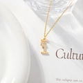 Gold chain necklace with letter I pendant featuring a zircon flower detail - Letter I